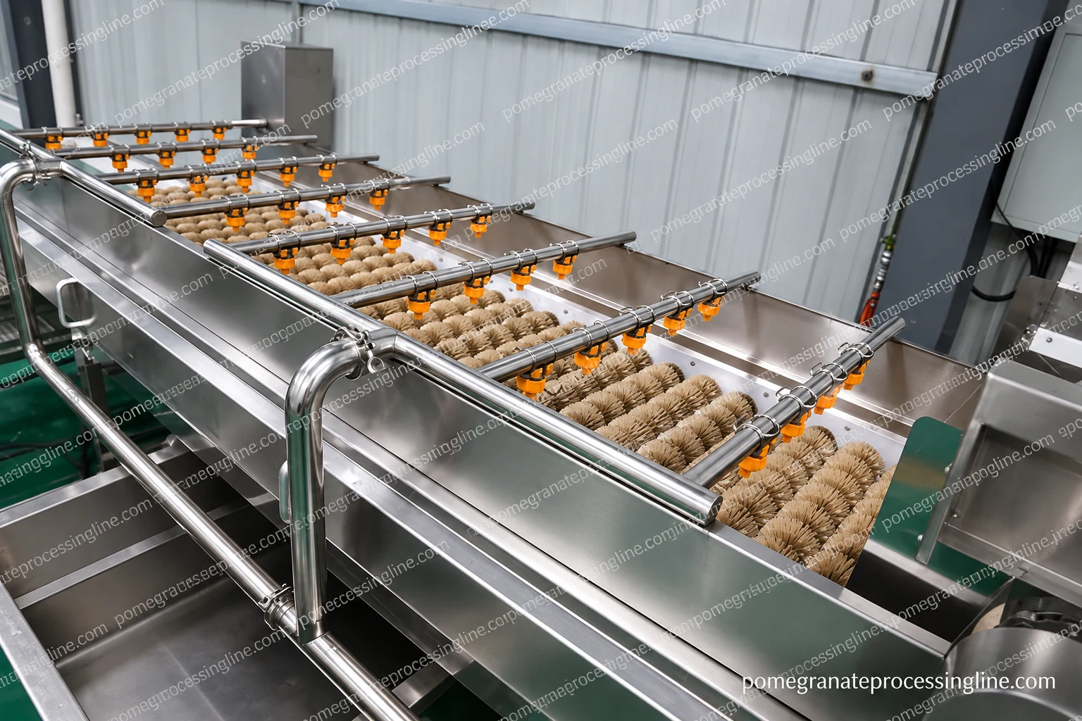Stainless washing trough containing brush rolls under spray bars with orange nozzles