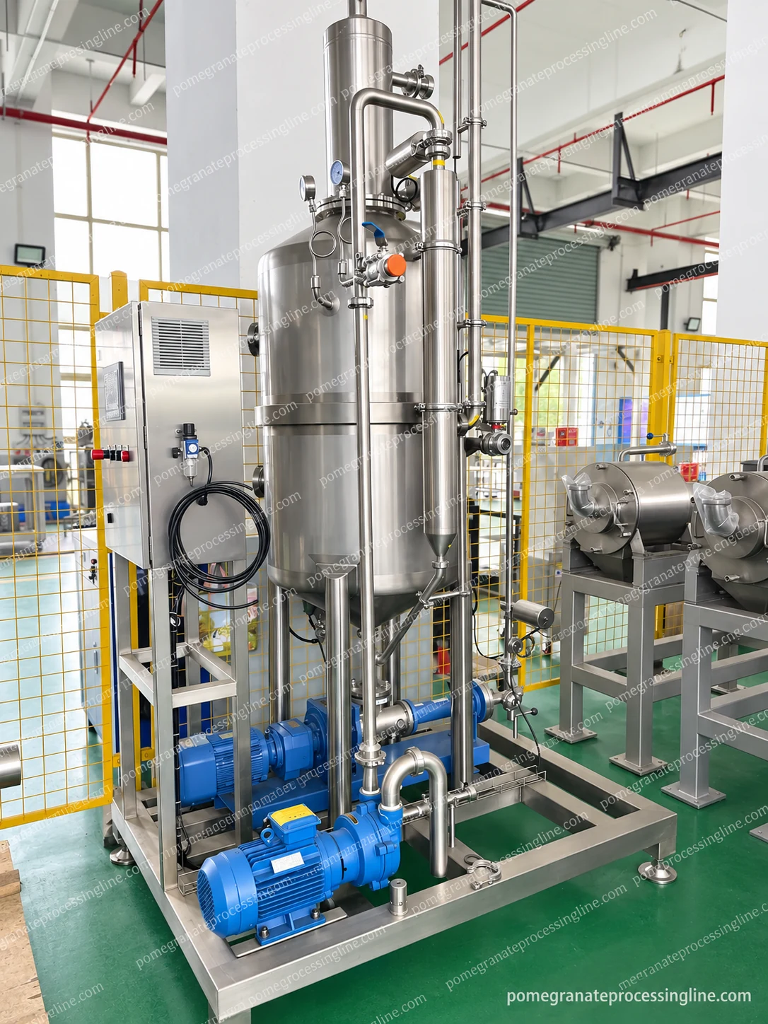 Vertical vacuum-vessel skid with upper pipework, gauges, lower blue pump drives and a left-side control cabinet